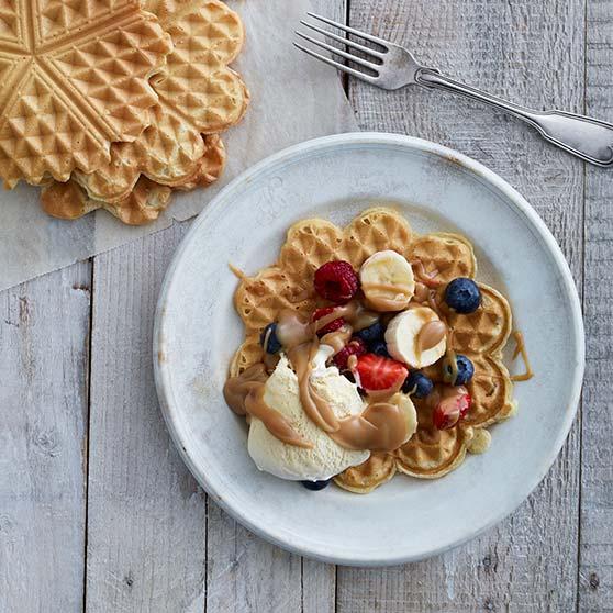 Waffles with salted caramel, banana and berries